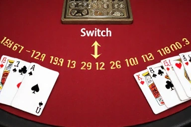 Two blackjack hands on a table, with arrows indicating the ability to switch top cards between them.